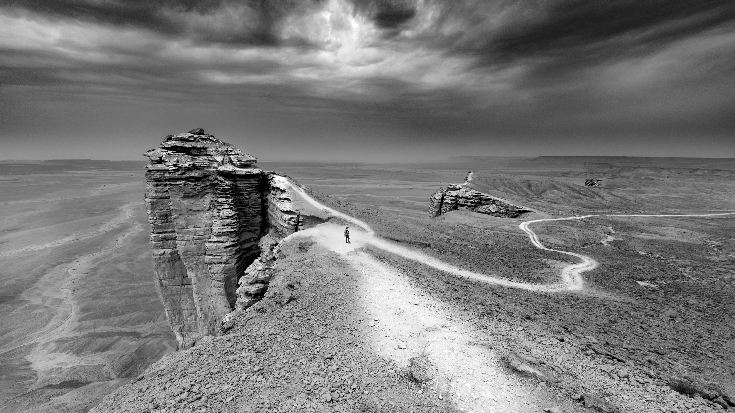 Black and white desert photograph of a lone figure